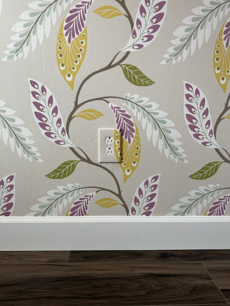 wallpaper installation near denver showcasing beautiful water done professionally over an outlet